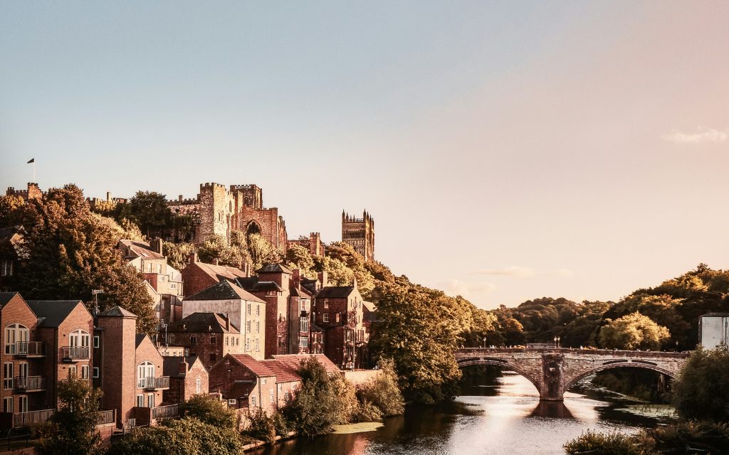 Photo of Framwellgate Bridge, a medieval bridge, with castle and cathedral behind it